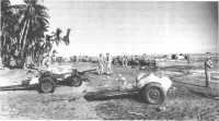 37-mm guns of Americal 
Division antitank units are landed on the beach at Guadalcanal as Army troops arrive to relieve 1st Division Marines