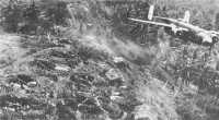 Japanese antiaircraft 
crews abandon their 75-mm guns at Rabaul during strafing runs by Army Air Forces B-25s