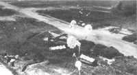 Parafrag bombs drop 
toward Japanese Bettys in revetments at Vunakanau field during a B-25 attack in October 1943