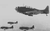 Headed for Vunakanau, a 
formation of Marine SBDs with bombs suspended from their wings takes part in the April strikes on Rabaul