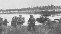 First wave ashore on Los 
Negros, troopers of the 1st Cavalry Division, advance toward Momote airfield