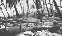 Machine gun ammunition 
bearers race forward to the front lines at the height of the battle for Tarawa