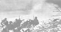 Marine heavy machine guns 
fire at Japanese defenses 400 yards ahead on the beach at Eniwetok Island