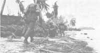 3rd Division assault 
troops take cover along the Asan beaches as messengers crouch low to avoid enemy fire