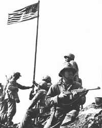 Men of the 28th Marines 
raise Old Glory on Mt
