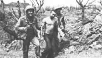 Prisoner captured by 5th 
Marine Division near Hill 165 is escorted to the rear for interrogation