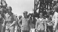 General Clement looks 
over Yokosuka Naval Base after its surrender by the former commander (r