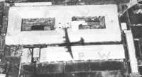 Shadow of a B-29 on a 
supply-drop mission passes over the POW camp at Nagasaki