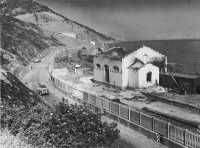 Coast road patrol passing 
the bombed-out Castelbuono railroad station, 24 July