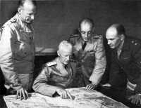 Admiral Nimitz discusses 
the Solomon campaign with (from left, standing) General Patch, Admiral Ghormley, and General Harmon at Nouméa, 
October 1942