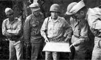General Griswold and 
General Harmon (center) being briefed on the tactical situation by 3rd Marine Division officers