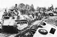 Japanese Light Tanks moving 
toward Manila on the day the city was entered