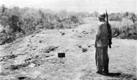A marine surveys foxholes 
along the ridge where Colonel Edson’s raider-parachute battalion fought off the Kawaguchi Force