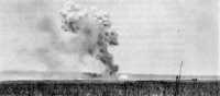 Japanese attacks on the 
airfield by daylight bombers and “Tokyo Express” warships created scenes such as this explosion of a large 
enemy bomb near a hanger