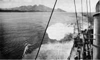 A destroyer steams along 
the coast farther west to hit Japanese positions