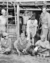 Japanese prisoners at 
Dobodura eating canned rations supplied by Australian soldiers