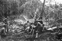 Men of 152nd Field 
Artillery Battalion firing a 105-mm