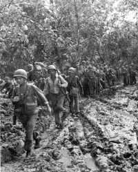 37th Division troops moving 
inland from the beach over a slimy mud trail, 8 November 1943