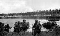 First wave of landing craft 
unloading men of G Troop, 2nd Squadron, 5th Cavalry, 29 February 1944