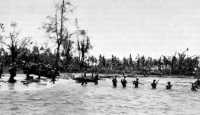 Crossing the Lorengau River 
over the sandbar at the mouth of the river, 18 March 1944