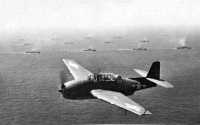 Southern Attack Force 
steaming toward the Gilberts; in the foreground a TBF-1 Avenger performs an antisubmarine patrol