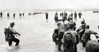 105th infantrymen wading in 
from the reef on 17 June