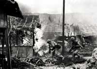 Marines dash through 
blazing Garapan, 2 July