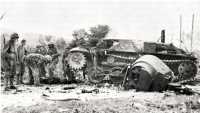Marines examining destroyed 
enemy tank, which was knocked out by a battery from the 10th Marines during the Japanese banzai attack