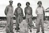 Marine Corps officers with 
plaque taken from the wreckage of the old Marine Corps barracks on Guam