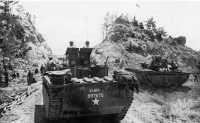 96th Division troops in 
amphibian tanks turned south on the right flank and paused just north of Sunabe to reconnoiter; here they raised the 
American flag