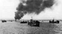 Japanese air and sea 
attack on transports left supply craft beached and still burning the morning of 4 May