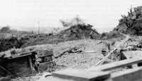 7th Marine troops closing 
in on a Japanese-held cave in the Dakeshi Ridge hug the ground as an enemy mortar shell burst on crest