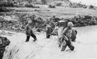 1st Division marines 
resort to hand carrying of supplies and wounded as roads are washed out by torrential rains