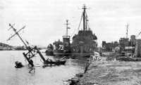 Rehabilitation of port 
at Naha was in progress when this picture was taken, 19 June 1945
