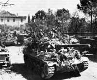 Camouflaged tank destroyers 
(M-18) moving up