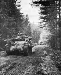 Tank destroyers M-10 of 
893rd Tank Destroyer Battalion, moving up over a narrow, muddy forest road west of Germeter