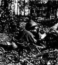 Army photographer wearing 
service gas mask with M1A2 face-piece, Camp Robinson, Arkansas, January 1942