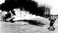 Operator firing a portable 
flame thrower E1R1 at a concrete fortification during a test of the weapon