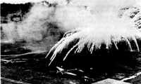 Burning phosphorus from a 
100-pound incendiary bomb on an enemy airfield, Rabaul, New Britain