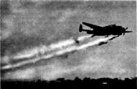 Lockheed A-29 spraying 
smoke from M33 smoke tanks visible under wings of craft