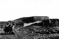 Men training with flame 
thrower against a captured German pillbox