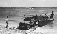 Jeep leaving landing craft 
comes ashore over Sommerfeld track in a training exercise, Camp Edwards, 1942