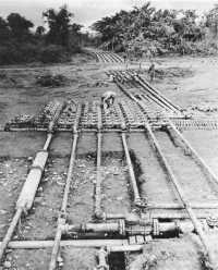 Manifold valve installation 
on pipeline paralleling the Ledo Road, China–Burma–India Theater, September 1944