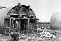 Men of the 829th Engineer 
Aviation Battalion erect Nissen hutting