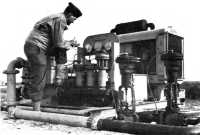 Engineer officer reads 
pressure gauges at pumping station, Foggia, Italy