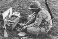 Soldier from the 39th 
Engineer Combat Regiment assembles M1A1 antitank mines at Anzio