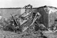 Bulldozer seals bunkers in 
the fortified line outside Aachen