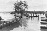 Troops float footbridge 
sections into place on the flooded Moselle River in the 90th Division area