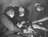 Team of 2nd Auxiliary 
Surgical Group operating on a wounded German soldier 94th Evacuation Hospital December 1943