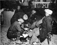 Treating Moroccan mountain 
troops of the French Expeditionary Corps for frozen feet at an aid station in the Venafro area